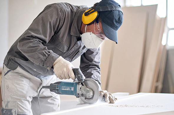 a plasterer cutting up plaster board