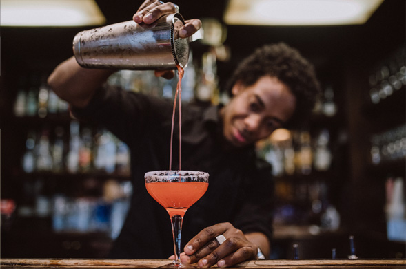 Barman pouring a cocktail