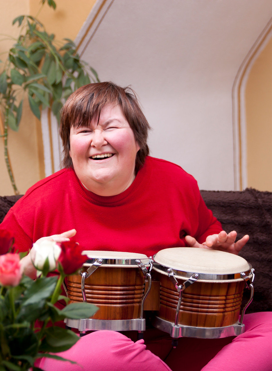 Woman playing drums on her lap